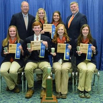 4-h'ers holding their blue ribbons from the skillathon contest as a team 