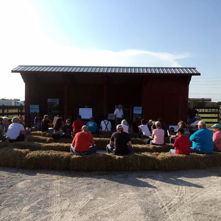 Image of agents speaking to producers at a field day 