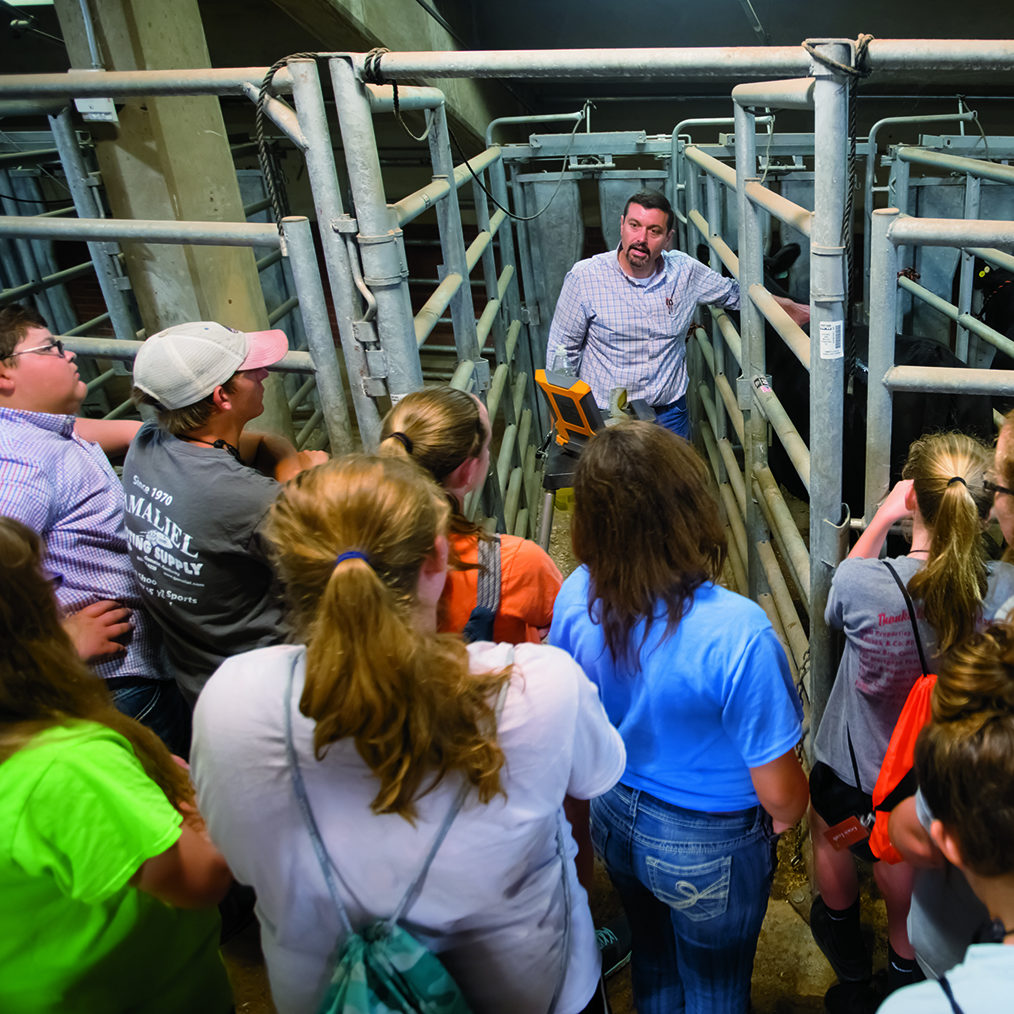 Professor talking with 4-h'ers at the 4-H academic conference 