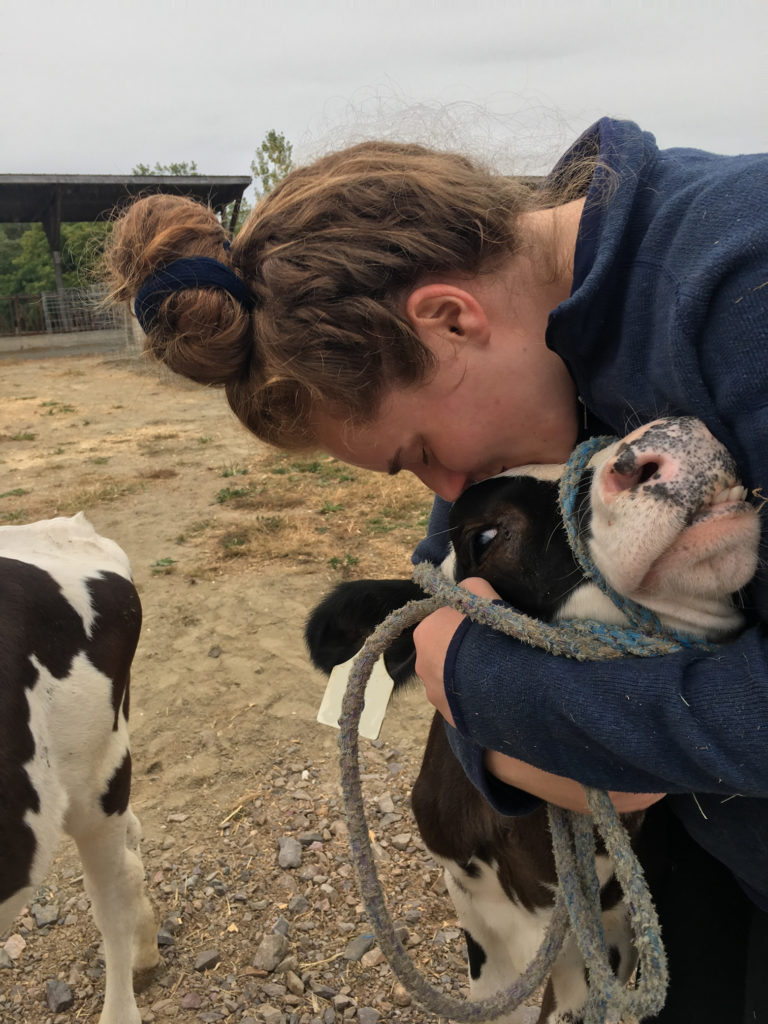 Hannah hugging her cow