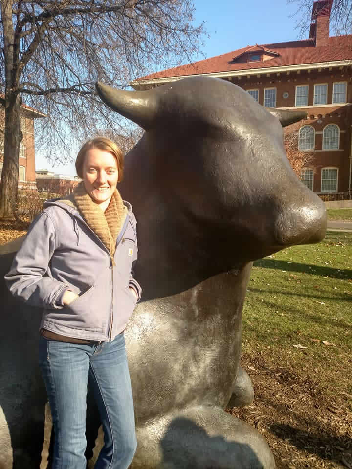 Katie in front of a bull statue