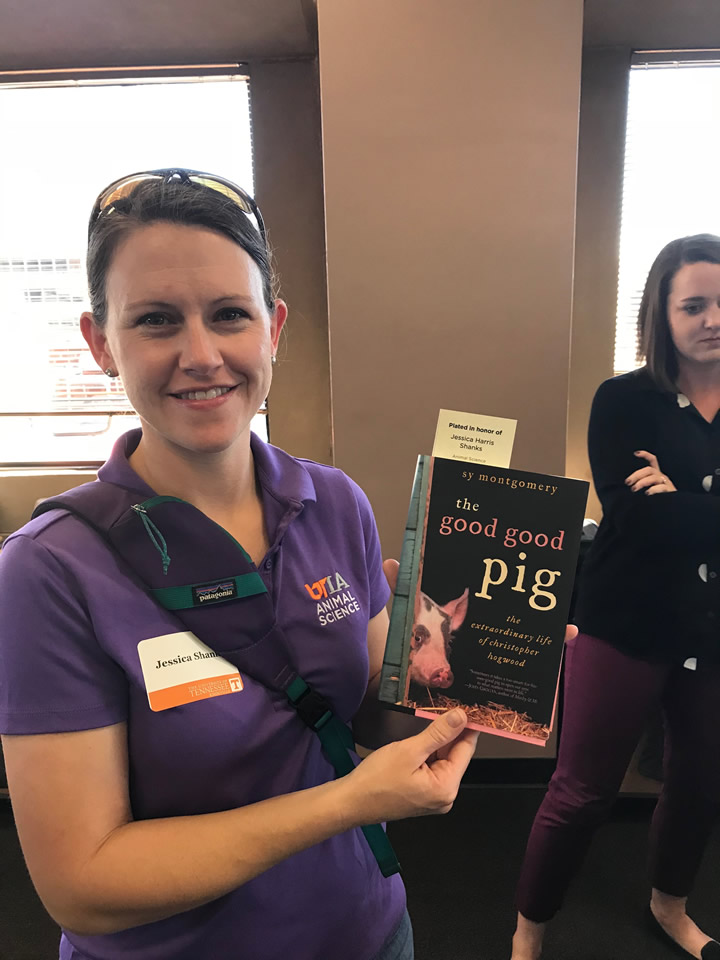 Jessy holding a book, the good good pig