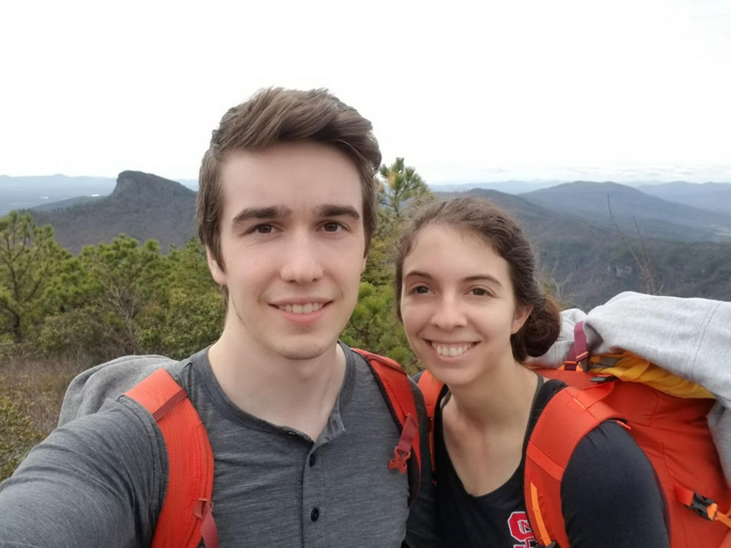 Casey and her companion doing a selfie with mountains in the background