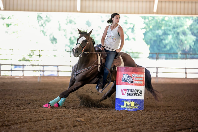 Amanda riding a horse in a competition