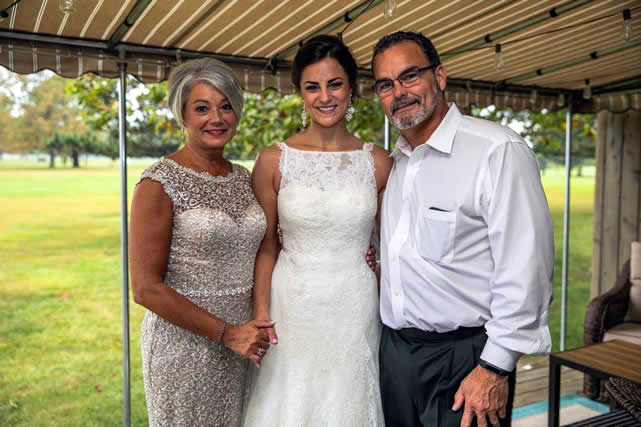 Amanda with her parents on her wedding day