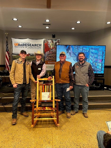 The Woods Rocker was awarded to the owners of the highest gaining bull from the 2023-2024 University of Tennessee Bull Development and Evaluation Program. Left to right: Chris Martin (Martin and Sons Farm); Dr. Neal Schrick (UT Animal Science – Department head); Neil Martin (Martin and Sons Farm); Dr. Saulo Zoca (UT Animal Science – Assistant Professor and Extension Beef Cattle Specialist).
