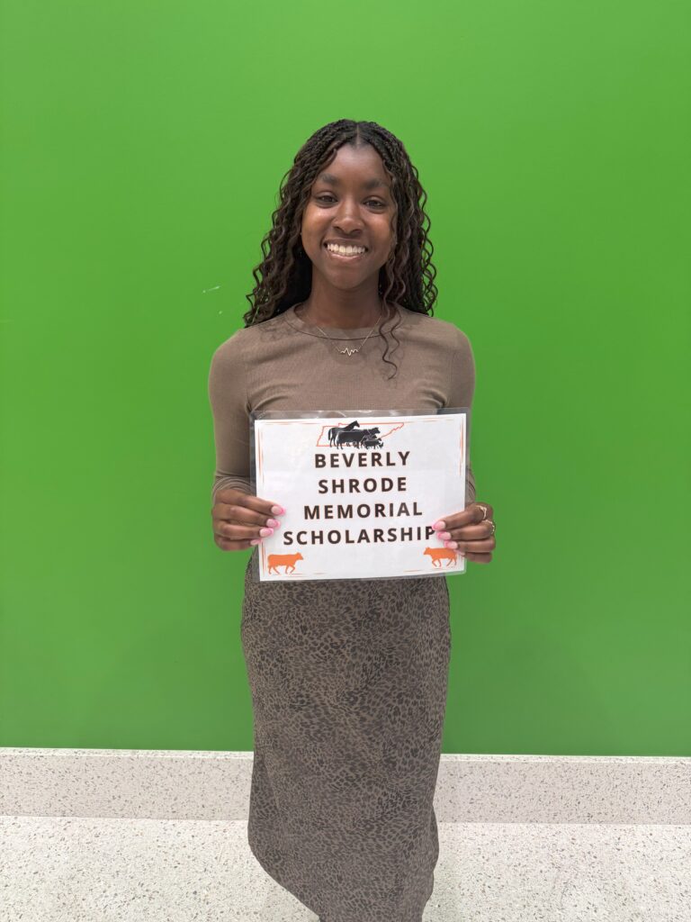 Student posing in front of green wall for the Beverly Shrode Memorial Scholarship
