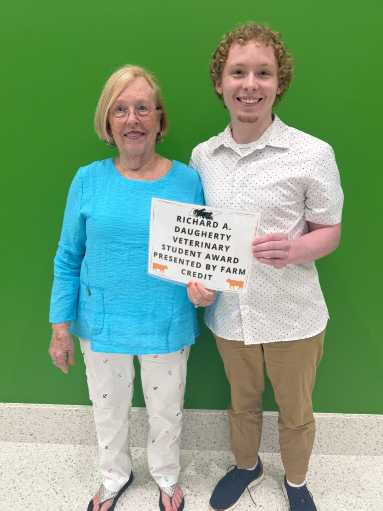 Martha representing farm credit is posing with student that won their scholarship.